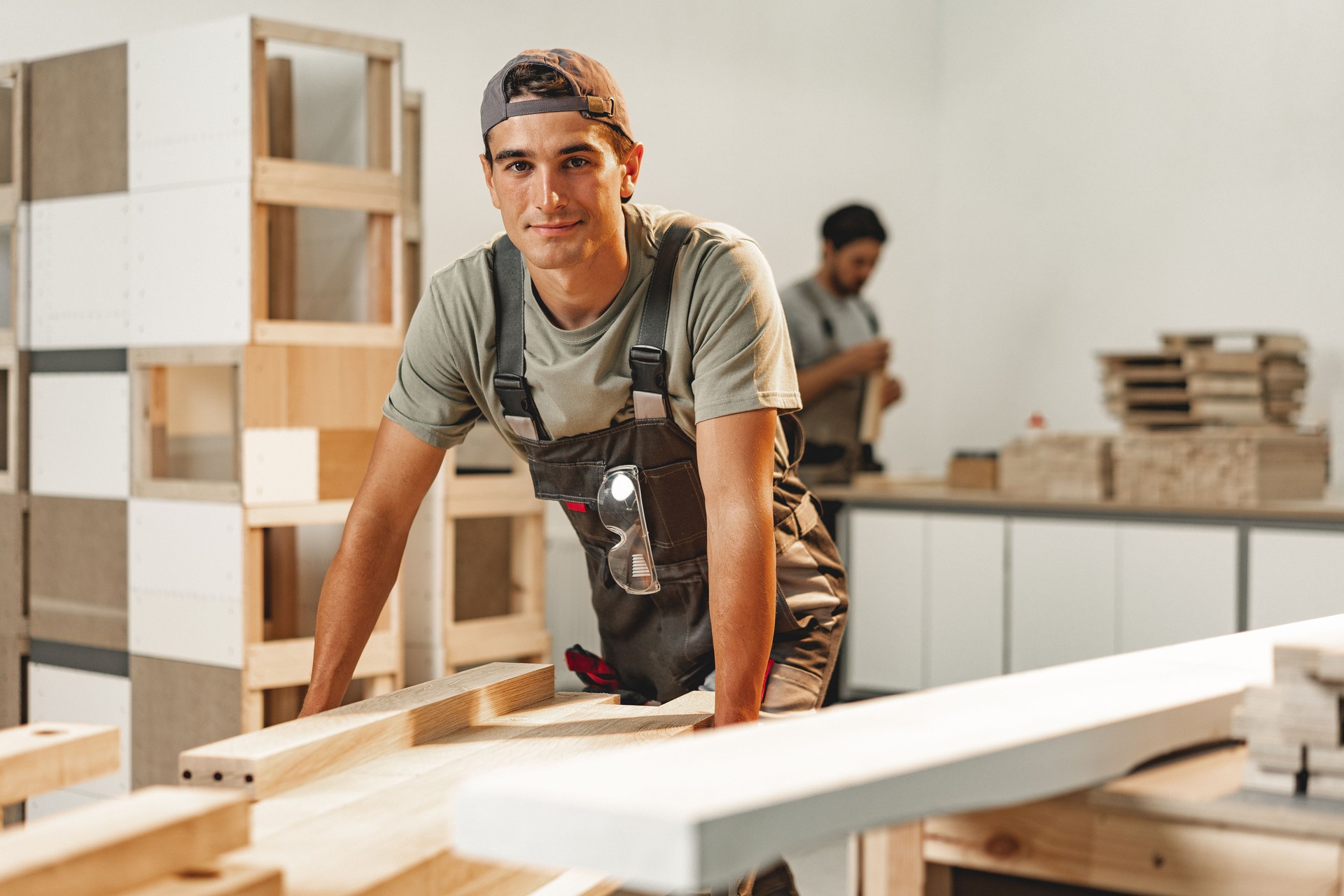 Portrait of young male carpenter standing in the wood workshop
